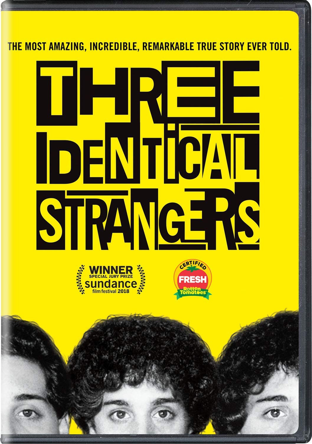 Three Identical Strangers The tops of three people's heads.