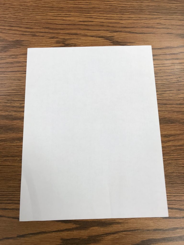 blank sheet of paper with slightly crumpled lower corner