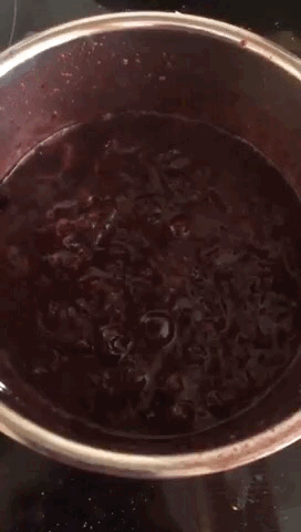Bubbling berries in a saucepan.
