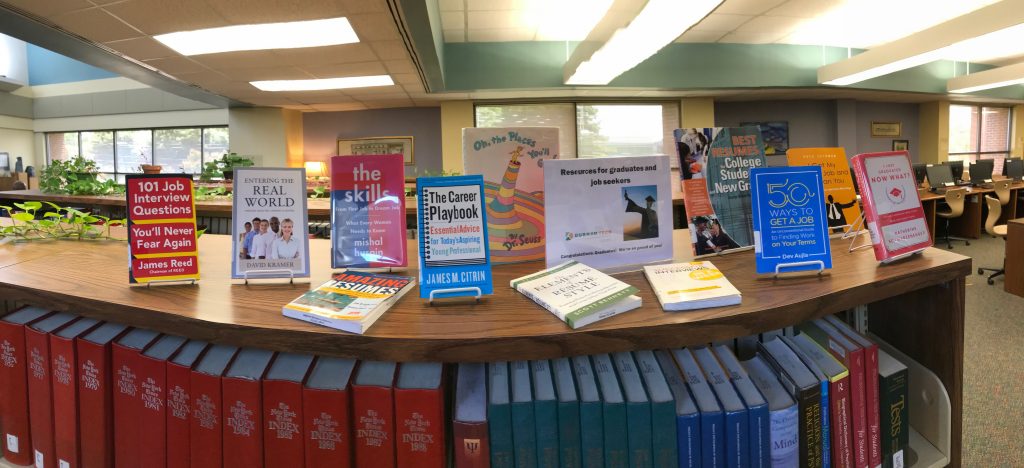 The Main Campus Library display of resources for graduates and job seekers, including 101 Job Interview Questions You'll Never Fear Again by James Reed, Entering the Real World by David Kramer, The Skills: From First Job to Dream Job, What Every Woman Needs to Know by Mishal Husain, Amazing Resumes, The Career Playbook: Essential Advice for Today's Aspiring Young Professional by James M. Citrin, Oh The Places You'll Go by Dr. Seuss, The Elements of Resume Style by Scott Bennett, Successful Interviews in a Week, Best Resumes for College Students and New Graduates, 50 Ways to Get a Job by Dev Aujila, I Got My Job and So Can You by Pete Leibman, I Just Graduated: Now What? by Katherine Schwarzenegger