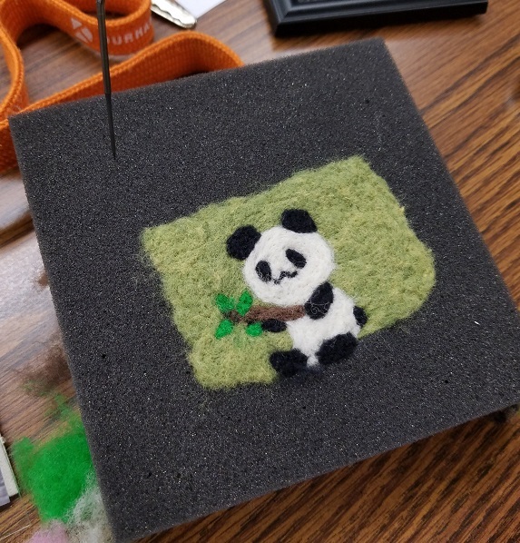 2-d image of panda made of felt on felting foam