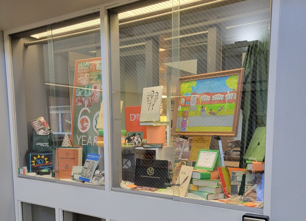 Full window display for the College's 60th Anniversary featuring materials from the Archives. 