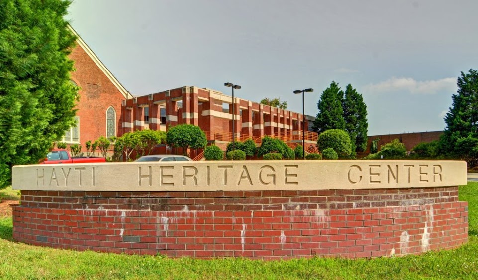 Hayti Heritage Center sign with St. Joseph's UME in the background